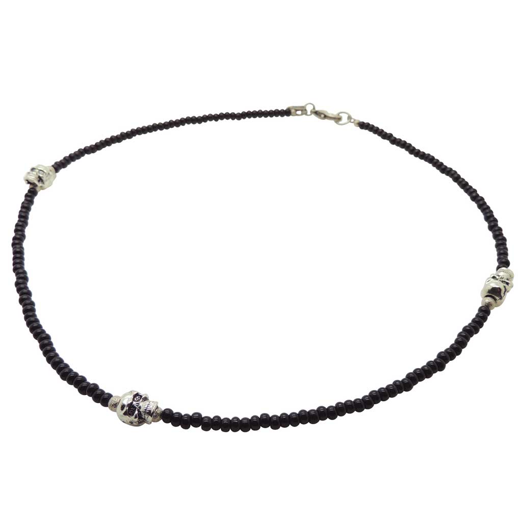 Dana Levy Black glass beaded necklace with silver skulls on a white background.