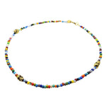 a gold plated skull charm trio multicolour glass bead mix necklace on a white background by Dana Levy