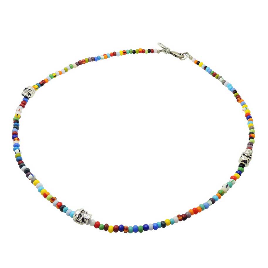 a multicolour and striped glass bead mix necklace with three silver plated brass skull charms and silver clasp. By Dana Levy