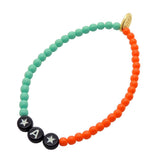 Dana Levy Personalised Name Colour Duo Glass Bead Bracelet - White Text on Black / Black Bead White Star Charm / Left: Aqua - Right: Orange Glass Beads