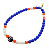 Dana Levy Initial Letter Charm Glass Bead Mix Bracelet with the Letter E, Royal Blue and White Opaque Glass Beads and Sun Orange Faceted Beads.