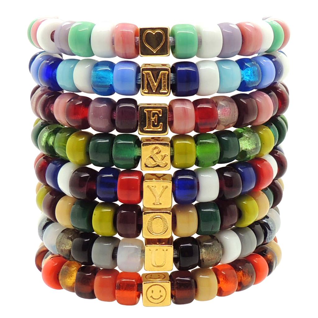 a Stack of Dana Levy Personalised Initial Alphabet Cube Charm Candy Bead Satin Cord Bracelets Spelling Out Me & You.