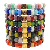 a Stack of Dana Levy Personalised Initial Alphabet Cube Charm Candy Bead Satin Cord Bracelets Spelling Out Me & You.