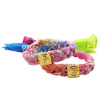 A pair of Dana Levy Alphabet Charm Bandana Braid Bracelets with Ombre Tie Dye Bandanas in various colours.