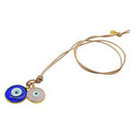 Dana Levy Evil Eye Disc Charm Duo Leather Cord Necklace with natural leather cord, and large transparent royal blue glass evil eye disc and small semi opaque pink glass evil eye disc pendants