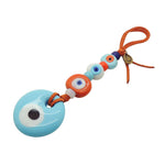 Dana Levy Glass Evil Eye Amulet Wall Hanging - Large opaque turquoise evil eye and orange white and turquoise small eyes on orange suedette cord. 
