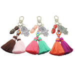 Dana Levy Mano Fico Hamsa Hand Evil Eye Trio Charm Tassel Bag Charm Trio with Silver Hamsa Hands and Brown Mint and Orange Evil Eye Charms. 