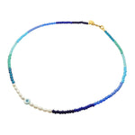 Dana Levy Ocean Pearl Amulet Bead Necklace  with a mother of pearl round tablet charm with evil eye. 