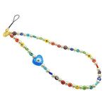 Dana Levy Rainbow Glass Evil Eye Heart Faux Pearl Beaded Phone Wristlet Strap with a transparent turquoise evil eye heart charm. 