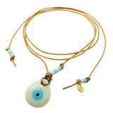 Dana Levy Glass Evil Eye Amulet Leather Lariat Cord Necklace with an opaque white evil eye amulet on bronze leather cord. 