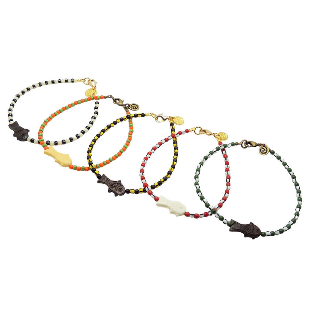 Dana Levy group of bone fish charm striped glass bead mix anklets with a variety of glass bead and striped glass bead colours on a white background. 