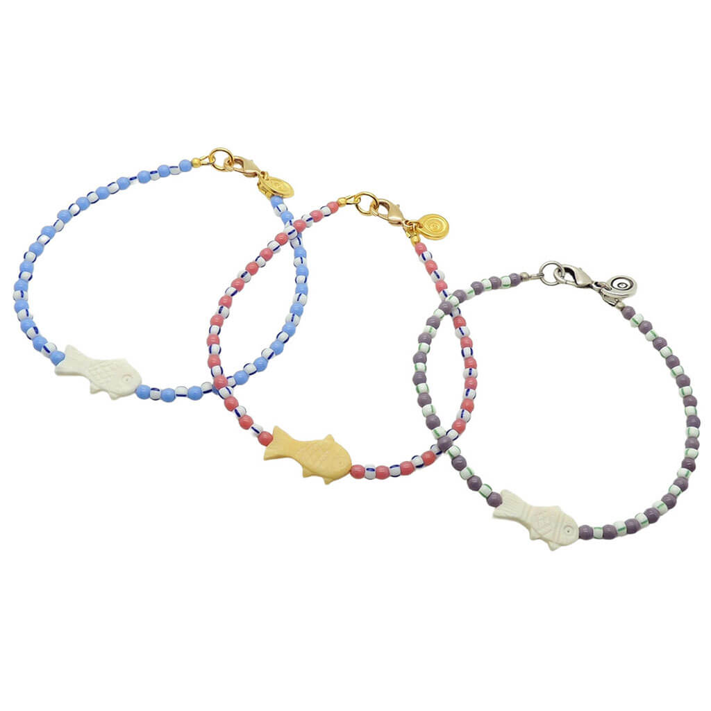 Dana Levy trio of bone fish charm striped glass bead mix anklets in pastel glass bead and striped bead colours on a white background. 