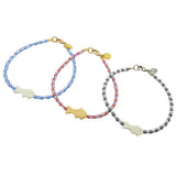 Dana Levy trio of bone fish charm striped glass bead mix anklets in pastel glass bead and striped bead colours on a white background. 