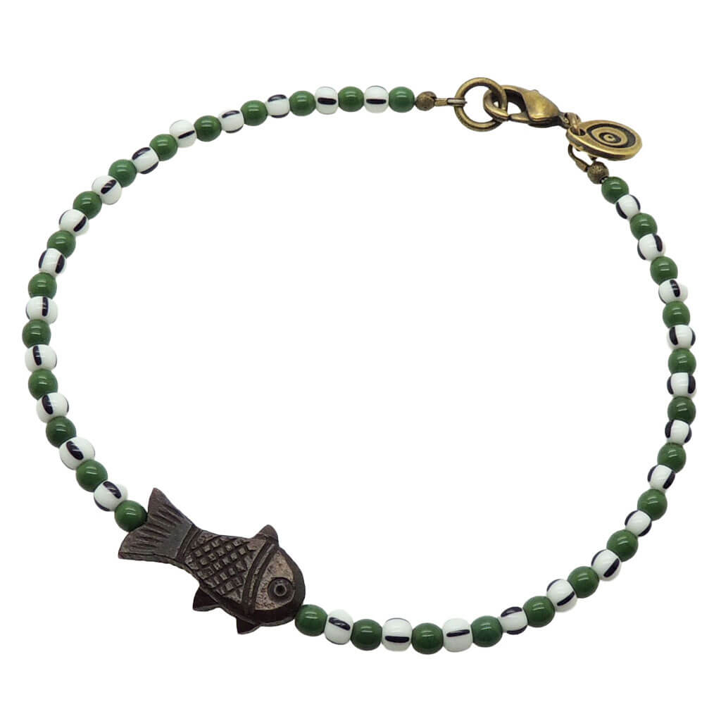 Dana Levy dark brown bone fish charm striped glass bead mix anklet with forest green glass beads and white/black striped glass beads and an antique gold plated clasp on a white background. 