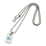 A Dana Levy men's silver ball chain necklace featuring a white rectangular dog tag pendant with a blue and black evil eye design, displayed on a clean white background.