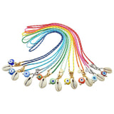 Dana Levy group of nautical cord necklaces with multicolour glass evil eyes and cowrie shell charms on a white background.