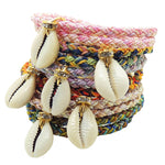 Dana Levy diamante cowrie shell charm braid cord bracelets in various colours on a white background. 