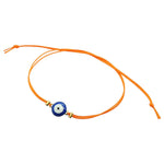 Dana Levy orange cord string bracelet with a navy blue evil eye charm on a white background