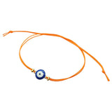 Dana Levy orange cord string bracelet with a navy blue evil eye charm on a white background