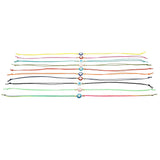 Dana Levy set of colourful cord string bracelets with evil eye amulet charms on a white background