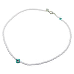 A Dana Levy baby pink glass rocaille bead necklace with aqua evil eye charms on a white background.