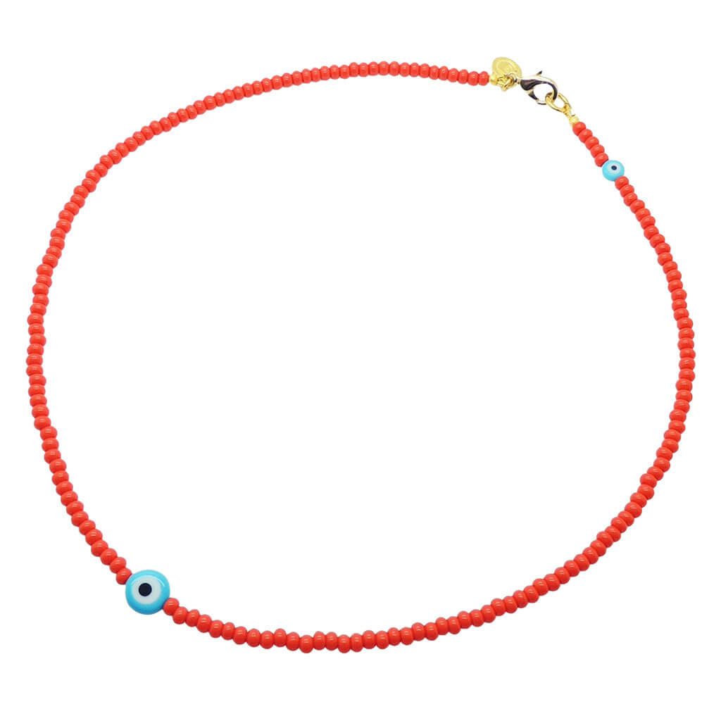 A Dana Levy tomato red glass rocaille bead necklace with opaque turquoise evil eye charms on a white background. 
