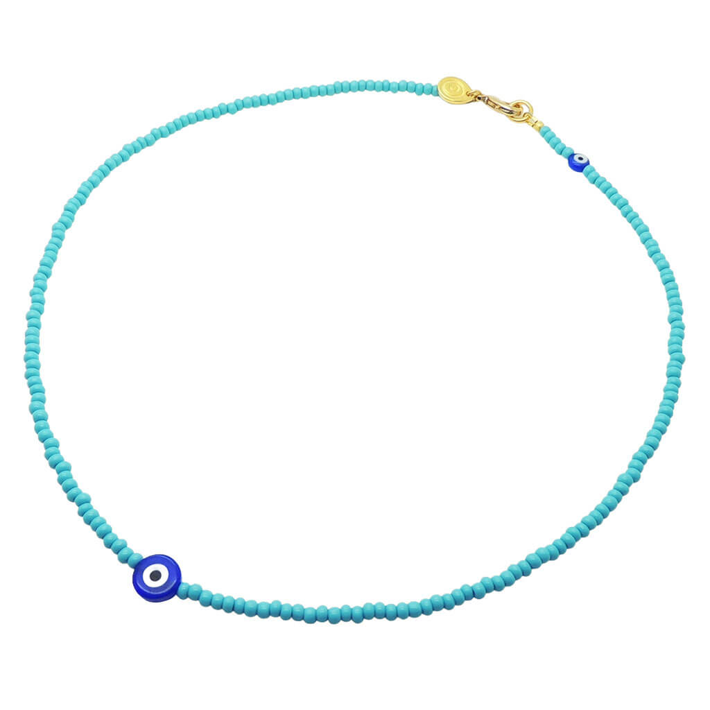 A Dana Levy teal glass rocaille bead necklace with royal blue evil eye charms on a white background.