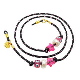 Dana Levy black sunglasses cord with colourful beads and gold clasp on a white background