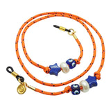 Dana Levy orange nautical glasses cord with decorative beads and charms on a white background