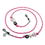 Dana Levy pink cord eyeglass holder with decorative lucky charm beads on a white background