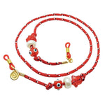 Dana Levy red nautical cord eyeglass holder with decorative charms and beads on a white background