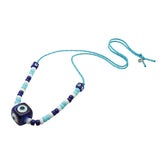 Dana Levy royal blue evil eye cube and turquoise white and navy glass beads on a turquoise cord necklace on a white background. 