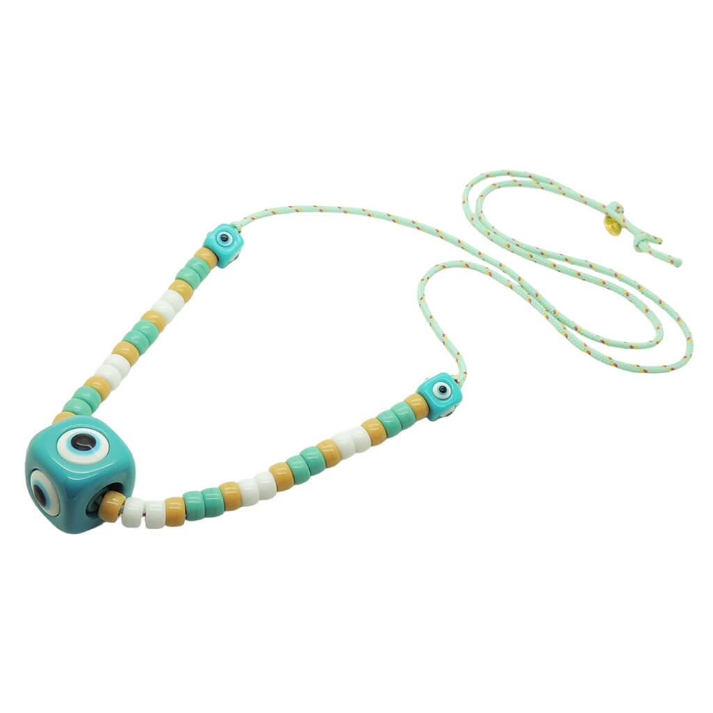 Dana Levy aqua evil eye cube and white, aqua and beige glass rondelle beads on a mint cord necklace on a white background. 