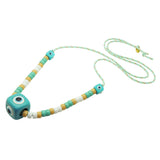 Dana Levy aqua evil eye cube and white, aqua and beige glass rondelle beads on a mint cord necklace on a white background. 