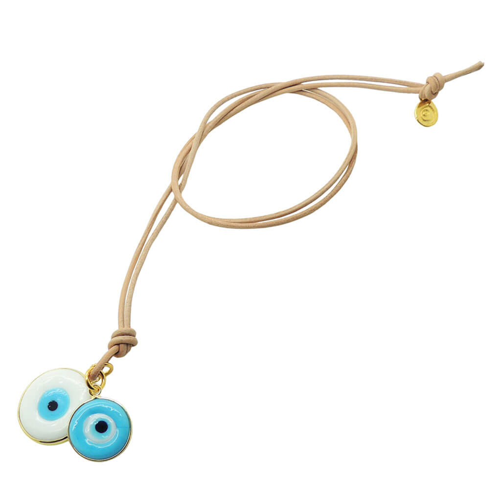 Dana Levy evil eye disc duo leather cord necklace with large white and small turquoise evil eye disc charms on natural leather cord on a white background. 