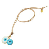 Dana Levy evil eye disc duo leather cord necklace with large white and small turquoise evil eye disc charms on natural leather cord on a white background. 