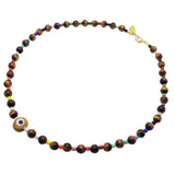 Dana Levy brown evil eye amulet necklace with multicoloured rainbow and tiger eye gemstone beads on a white background.