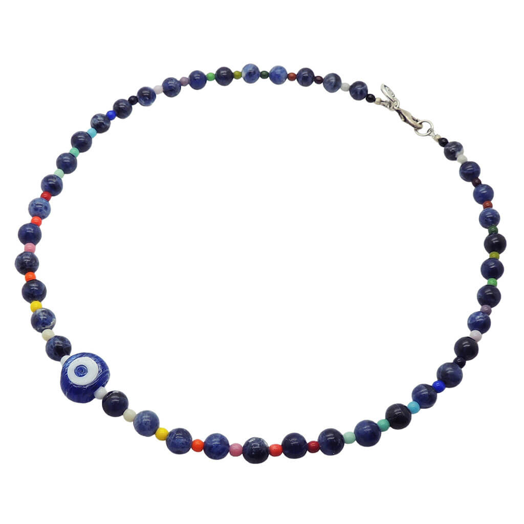 Dana Levy evil eye amulet necklace with multicoloured rainbow and sodalite gemstone beads on a white background.