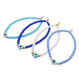 Dana Levy set of four evil eye star charm glass bead bracelets in various shades of blue and white with stardust beads. 