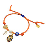 Dana Levy orange nautical cord bracelet with various lucky charms on a white background.