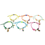 Dana Levy set of colourful nautical cord bracelets with various lucky charms on a white background.