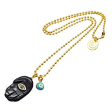 Dana Levy gold chain necklace with black hamsa hand pendant and blue evil eye charm on a white background