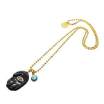 Dana Levy gold plated ball chain necklace with a black hamsa hand diamante pendant and blue evil eye charm on a white background