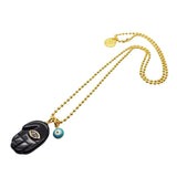 Dana Levy gold plated ball chain necklace with a black hamsa hand diamante pendant and blue evil eye charm on a white background