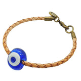 Dana Levy braided tan leather bracelet featuring a translucent royal blue glass evil eye bead with a white centre, secured with an antique bronze clasp on a plain white background.