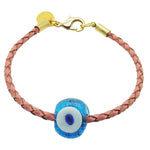 Dana Levy pink braided leather bracelet with a gold plated clasp and a transparent turquoise blue glass evil eye charm in the centre, shown on a plain white background.