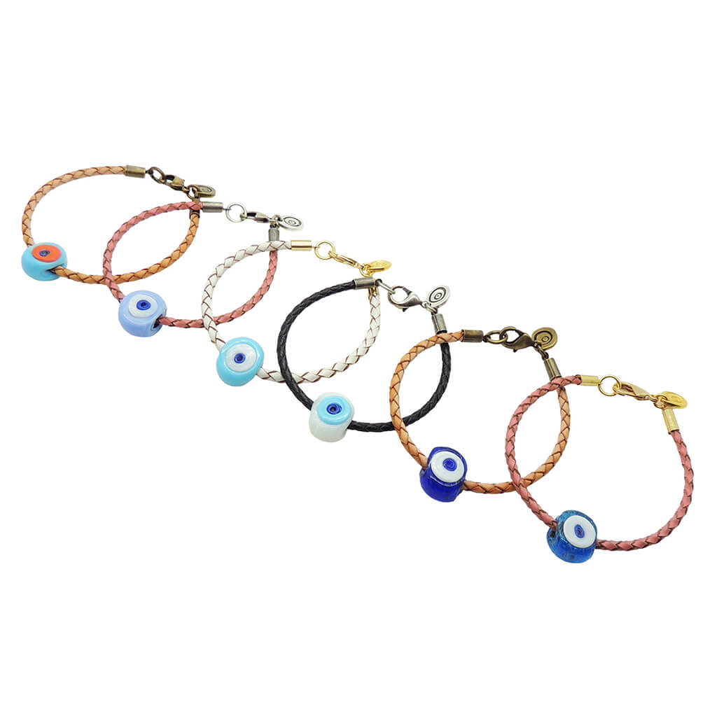 Dana Levy six braided leather cord bracelets with chunky glass evil eye bead charms in various colours, arranged diagonally on a plain white background.