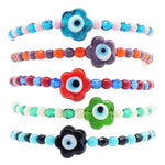 Dana Levy stack of glass evil eye flower charm glass bead mix bracelets in various colour mixes on a white background. 