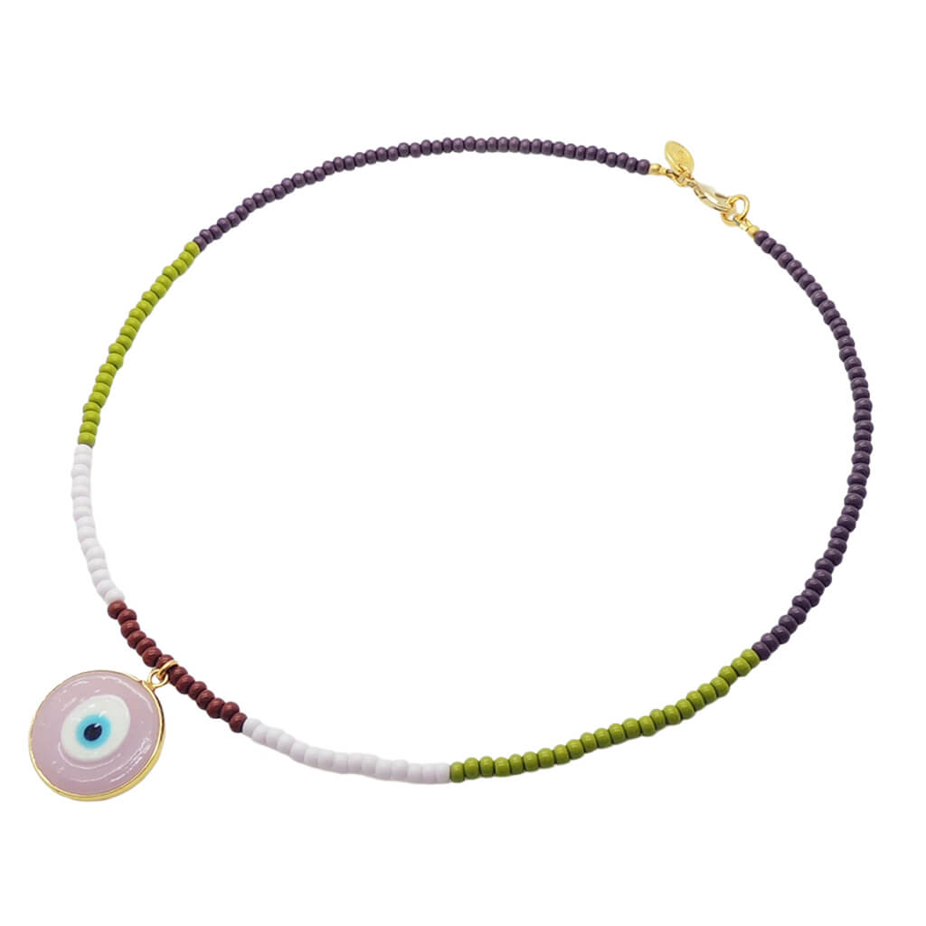 A Dana Levy glass bead necklace with purple, olive, baby pink and brown glass beads and a semi opaque pink glass evil eye pendant in the centre on a white background. 