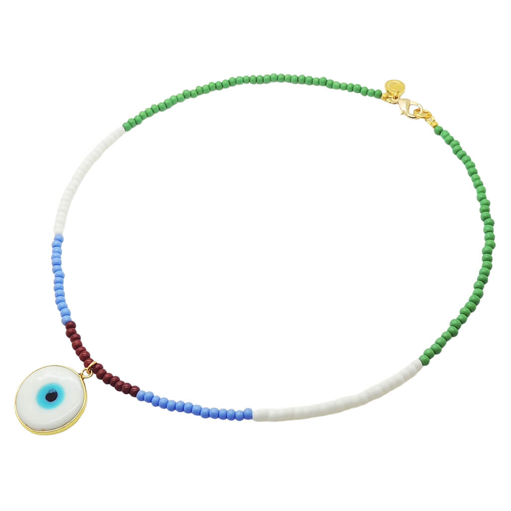 A Dana Levy glass beaded necklace featuring a white evil eye disc pendant, with sections of green, white, light blue, and dark brown beads, finished with a gold plated clasp.